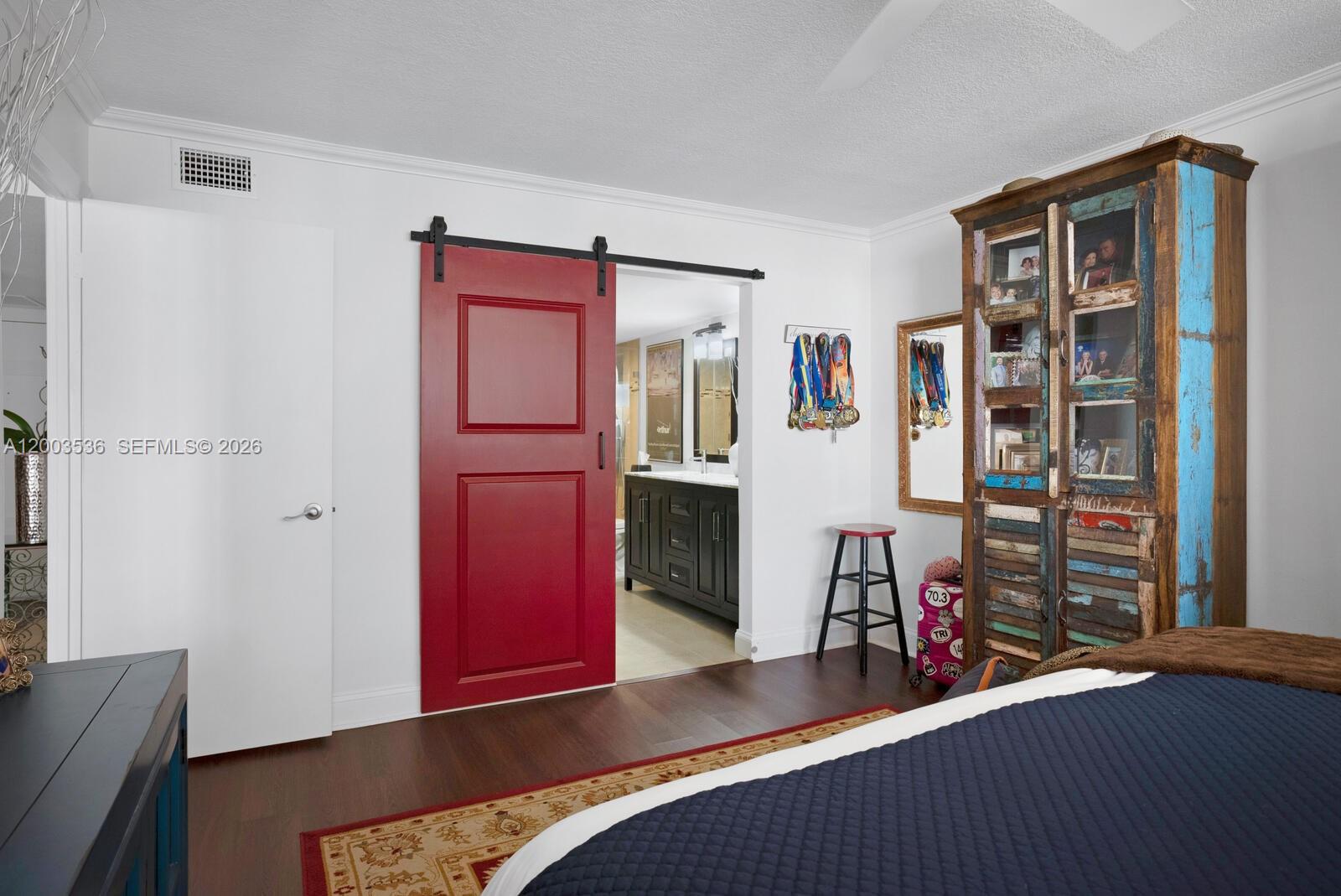 1925 Brickell Avenue, Unit 1003 Miami, FL 33129 - Photo 12 of 16 a bed room with a bed and a book shelf