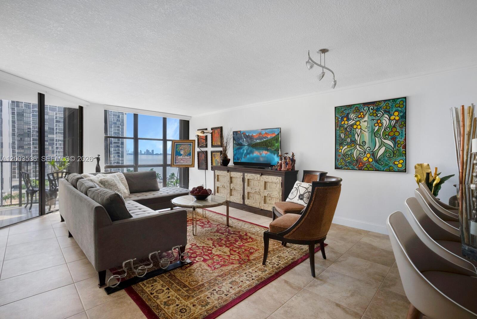 1925 Brickell Avenue, Unit 1003 Miami, FL 33129 - Photo 2 of 16 a living room with furniture and a rug