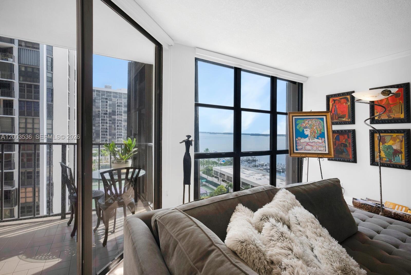 1925 Brickell Avenue, Unit 1003 Miami, FL 33129 - Photo 3 of 16 a bedroom with a large window and a balcony