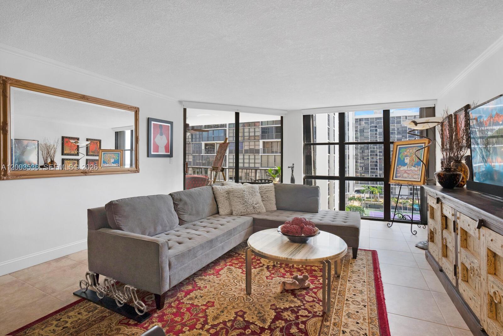 1925 Brickell Avenue, Unit 1003 Miami, FL 33129 - Photo 4 of 16 a living room with furniture and a flat screen tv