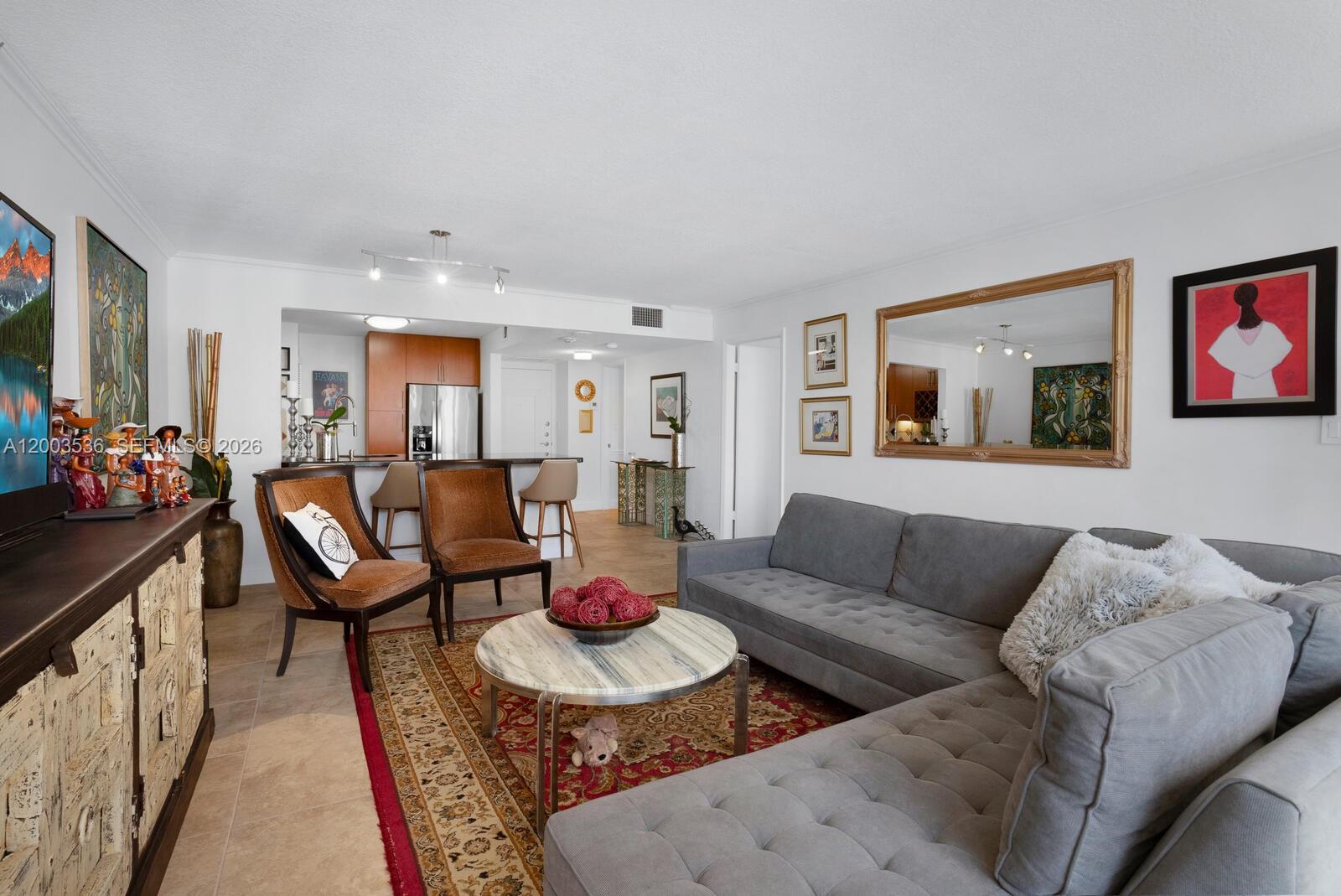 1925 Brickell Avenue, Unit 1003 Miami, FL 33129 - Photo 5 of 16 a living room with furniture and a couch