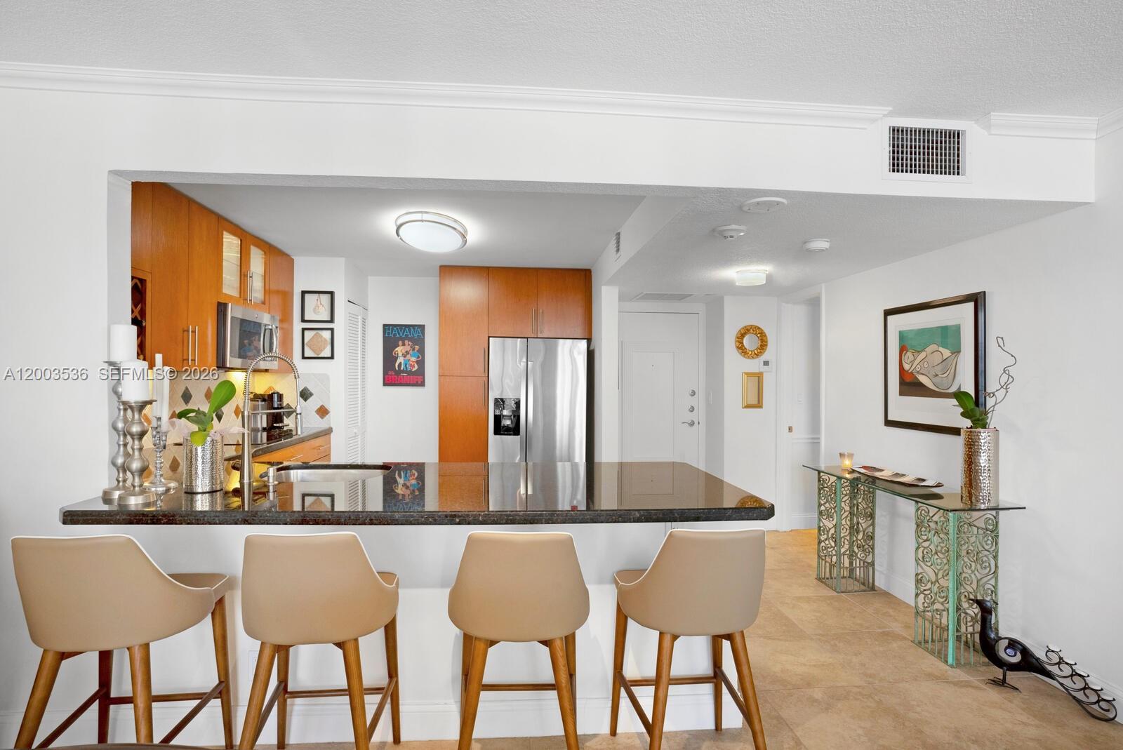 1925 Brickell Avenue, Unit 1003 Miami, FL 33129 - Photo 6 of 16 a kitchen with a dining table chairs and large window
