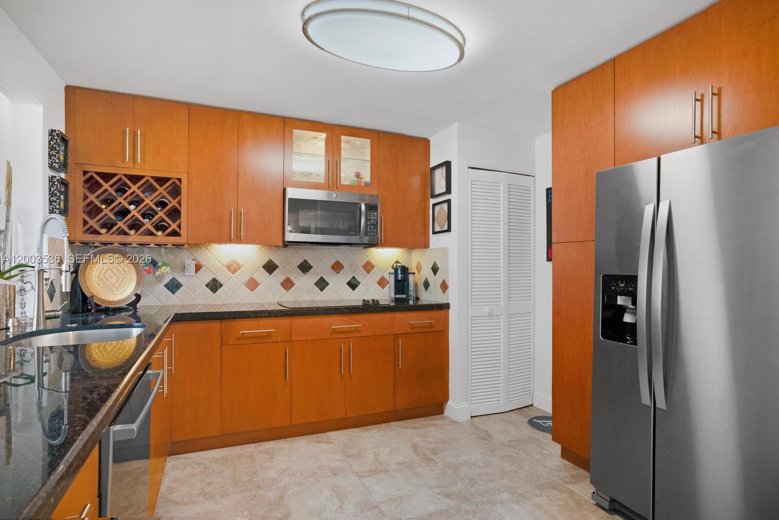 1925 Brickell Avenue, Unit 1003 Miami, FL 33129 - Photo 8 of 16 a kitchen with stainless steel appliances granite countertop a refrigerator and a stove