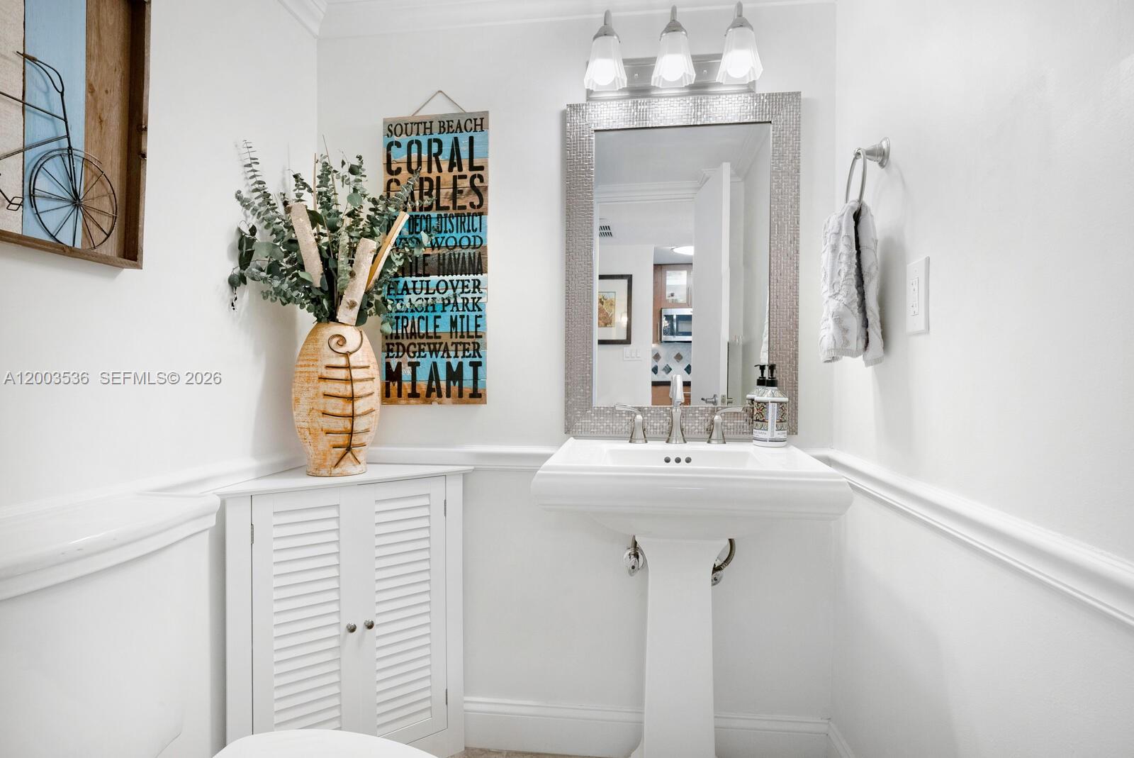 1925 Brickell Avenue, Unit 1003 Miami, FL 33129 - Photo 9 of 16 a bathroom with a sink and a mirror