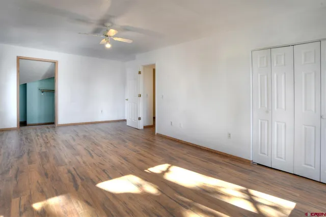 a view of an empty room and wooden floor
