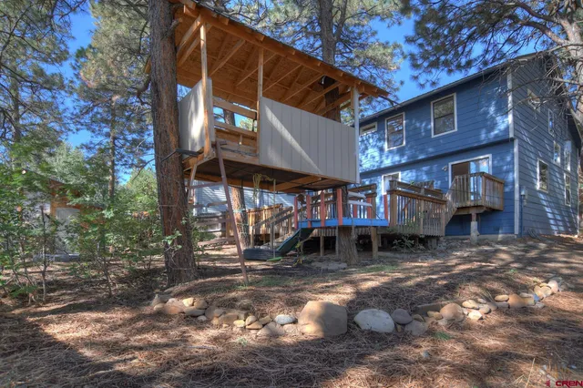 a view of a house with a tree