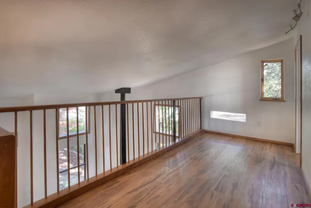 a bathroom with a granite countertop sink a mirror a bathtub and shower