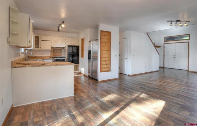 a view of a kitchen with wooden floor