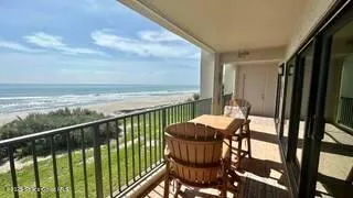 a view of a balcony with furniture