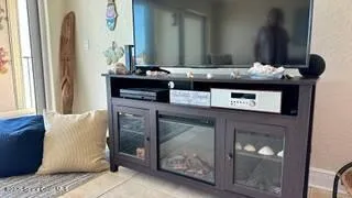 a view of a hallway with entryway and wooden floor