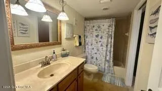 a bed room with a bed and a chandelier