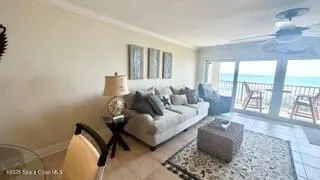 a living room with furniture and a lamp