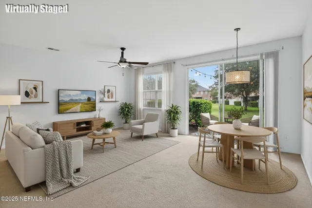 a living room with furniture and a large window
