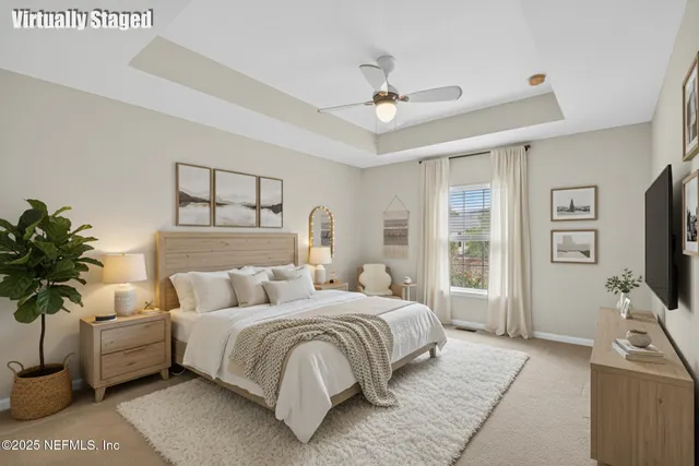 a bedroom with a bed couch and a flat tv screen