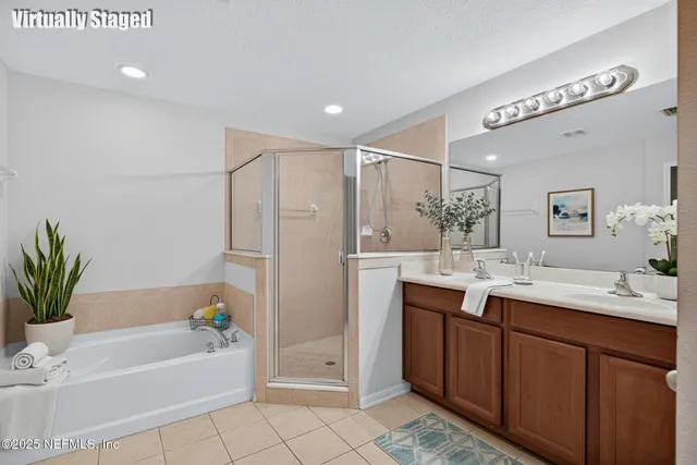 a bathroom with a bathtub a sink and a mirror