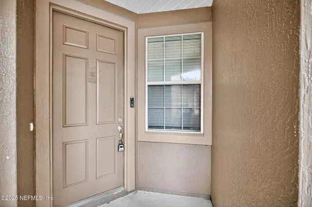 a view of an empty room with windows