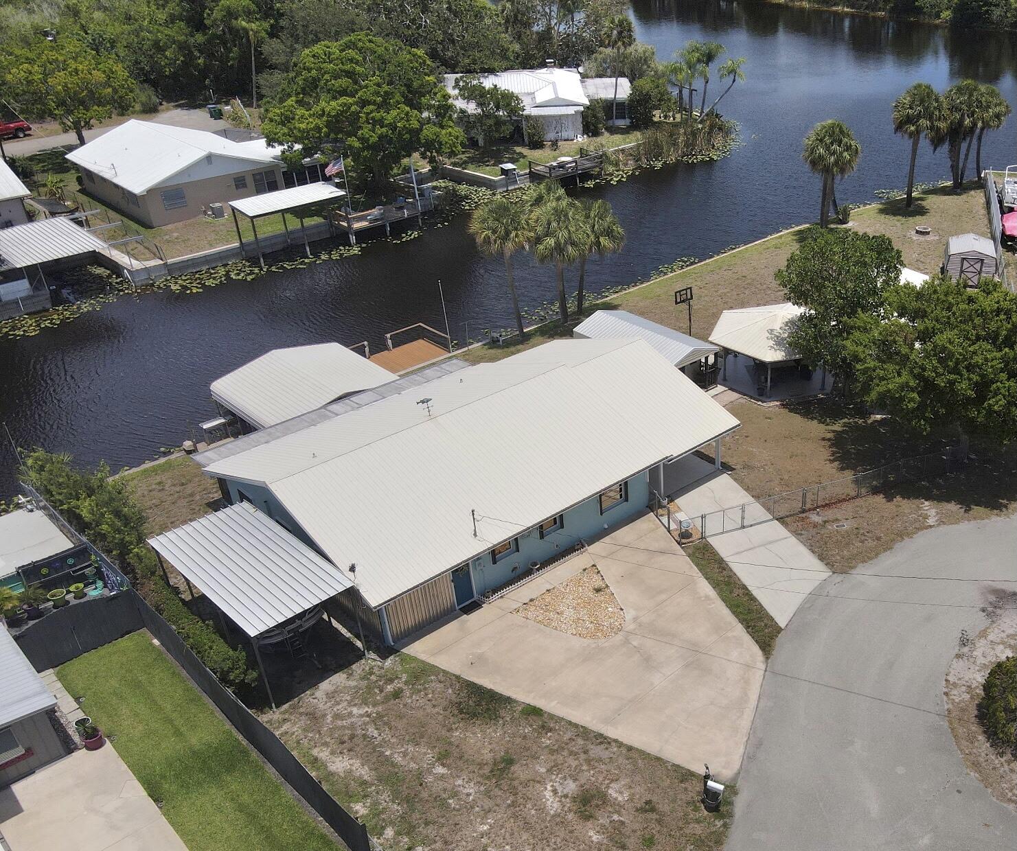 1115 Elm Street Okeechobee, FL 34974 - Photo 1 of 37 an aerial view of a house with outdoor space and lake view