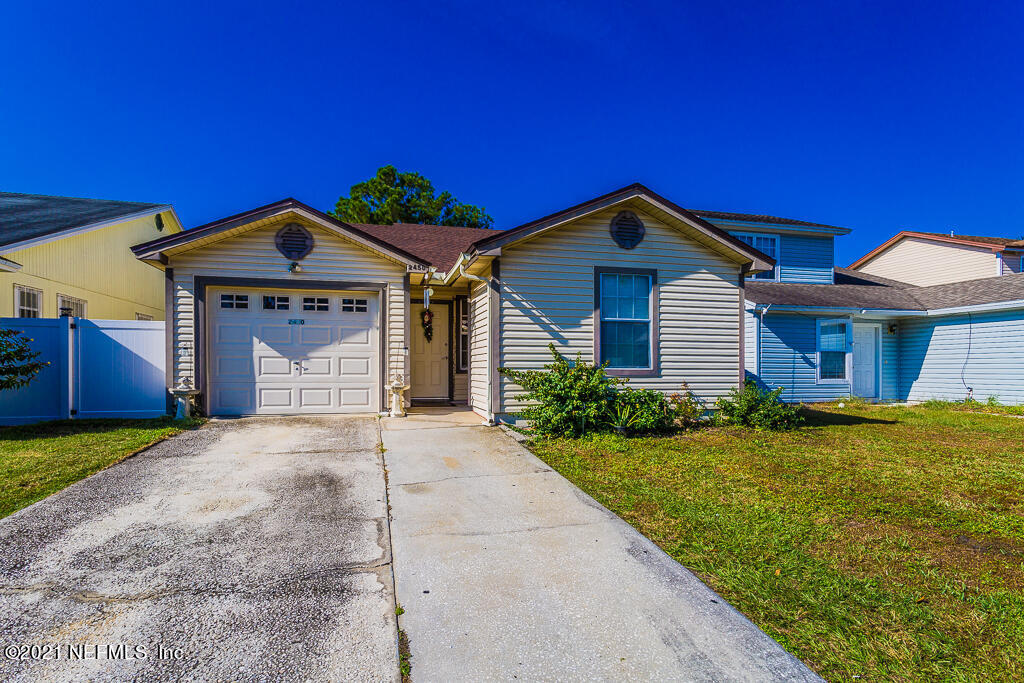 2450 Wattle Tree Road East Jacksonville, FL 32246 - Photo 1 of 24 a front view of a house with a yard