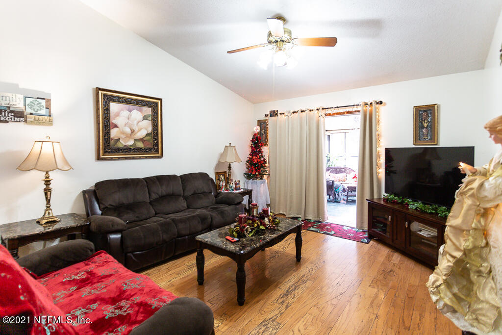 2450 Wattle Tree Road East Jacksonville, FL 32246 - Photo 14 of 24 a living room with furniture and a flat screen tv