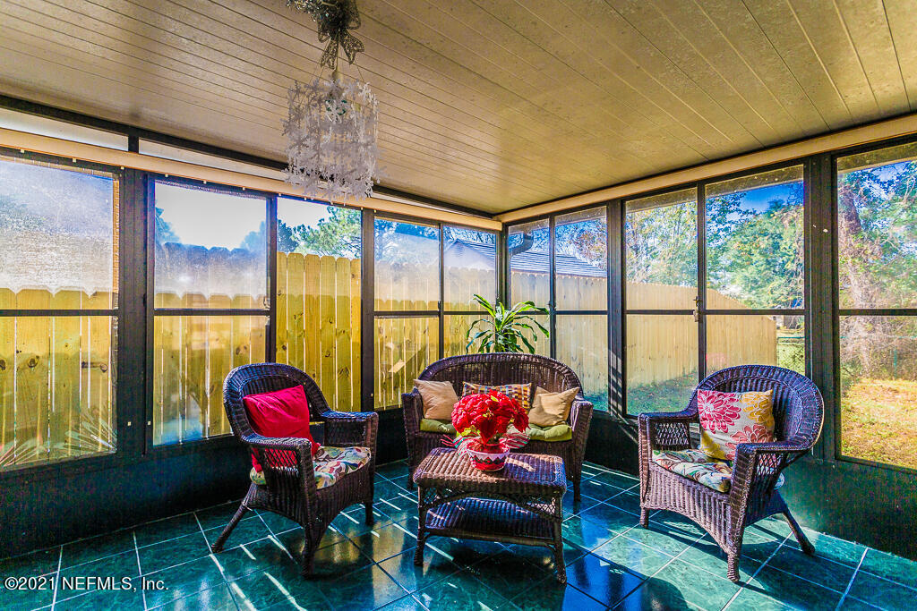 2450 Wattle Tree Road East Jacksonville, FL 32246 - Photo 20 of 24 a living room with furniture and a floor to ceiling window