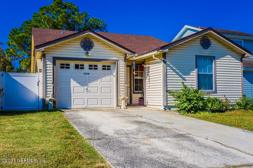 2450 Wattle Tree Road East Jacksonville, FL 32246 - Photo 2 of 24 a front view of a house with a garden