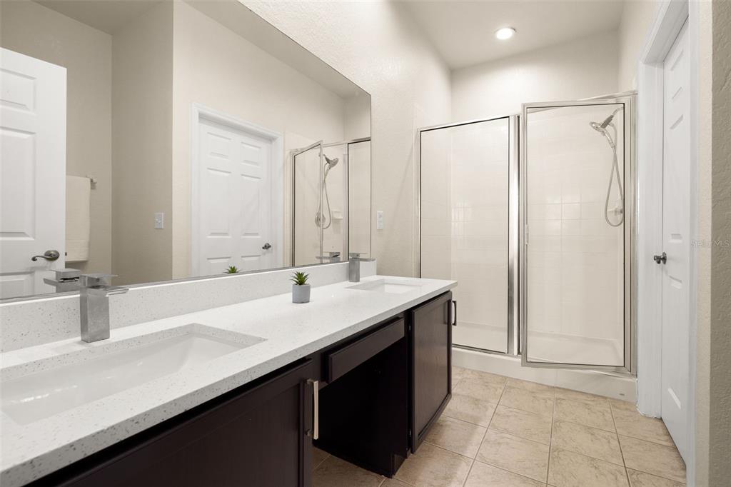 3001 Greystone Loop, Unit 106 Kissimmee, FL 34741 - Photo 12 of 27 a bathroom with a double vanity sink a and mirror