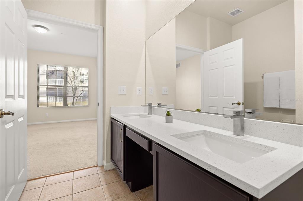 3001 Greystone Loop, Unit 106 Kissimmee, FL 34741 - Photo 13 of 27 a bathroom with a sink and a mirror