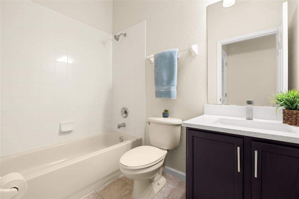 3001 Greystone Loop, Unit 106 Kissimmee, FL 34741 - Photo 15 of 27 a bathroom with a sink a toilet and shower