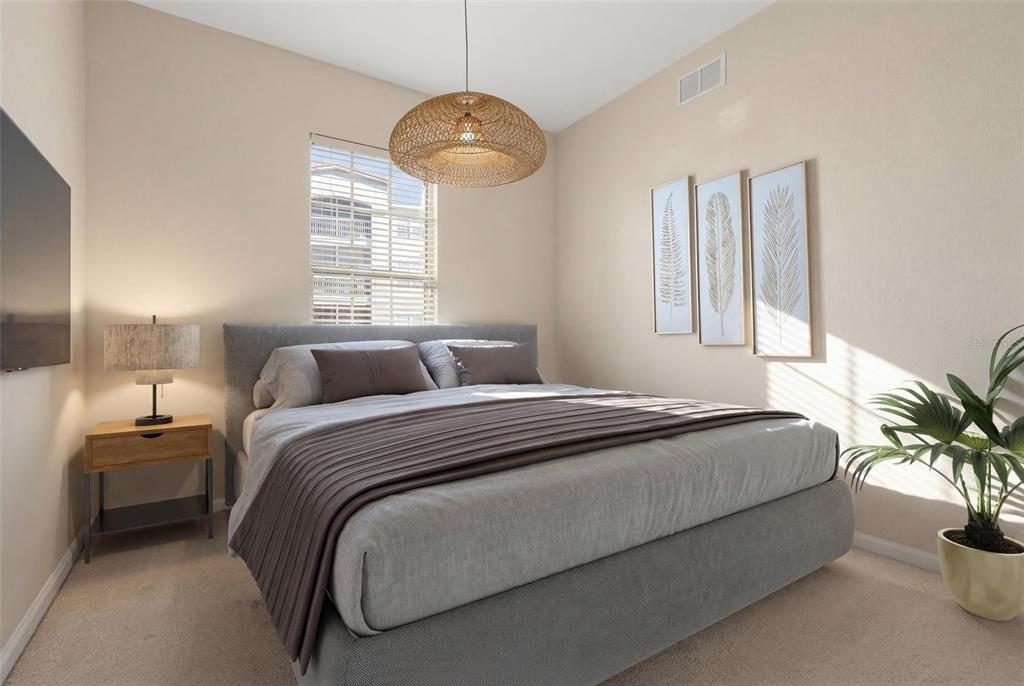 3001 Greystone Loop, Unit 106 Kissimmee, FL 34741 - Photo 16 of 27 a bedroom with a bed and a potted plant