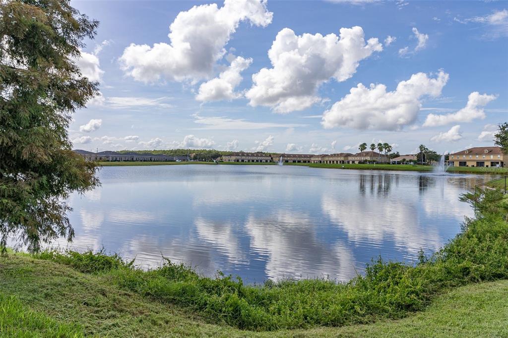 3001 Greystone Loop, Unit 106 Kissimmee, FL 34741 - Photo 26 of 27 a view of a lake with a building in the background
