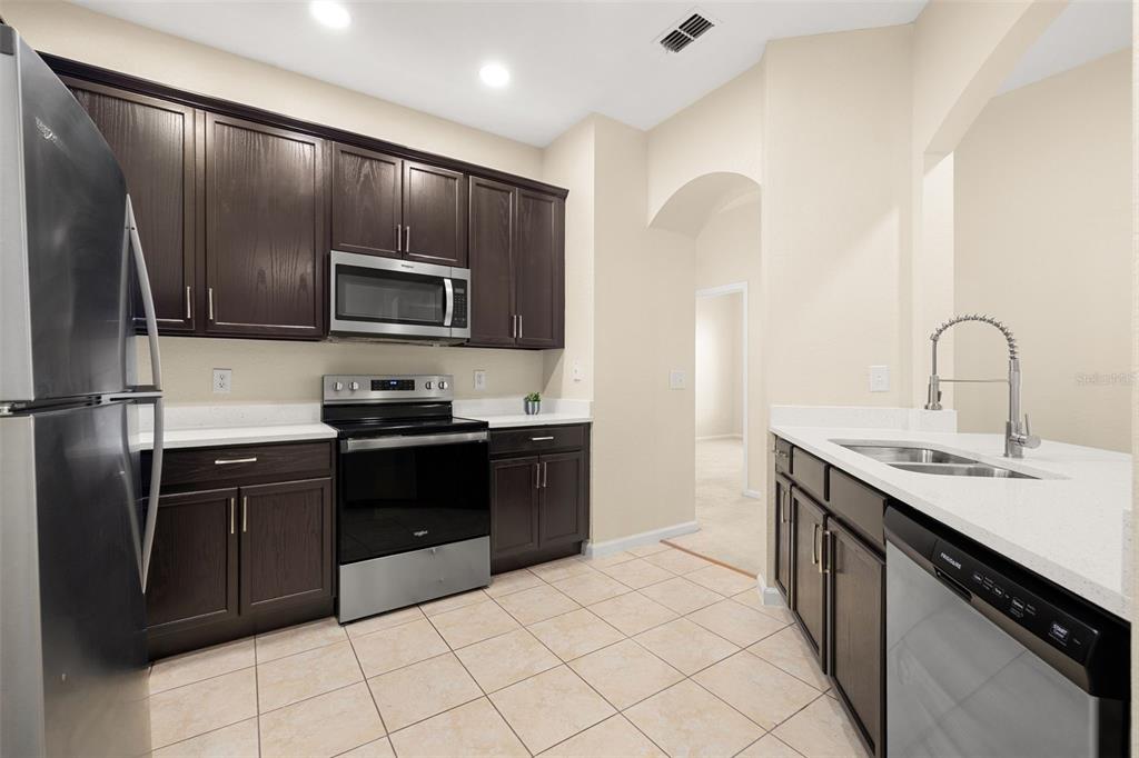3001 Greystone Loop, Unit 106 Kissimmee, FL 34741 - Photo 4 of 27 a kitchen with a refrigerator sink and microwave