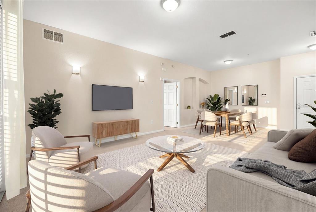 3001 Greystone Loop, Unit 106 Kissimmee, FL 34741 - Photo 8 of 27 a living room with furniture and a flat screen tv