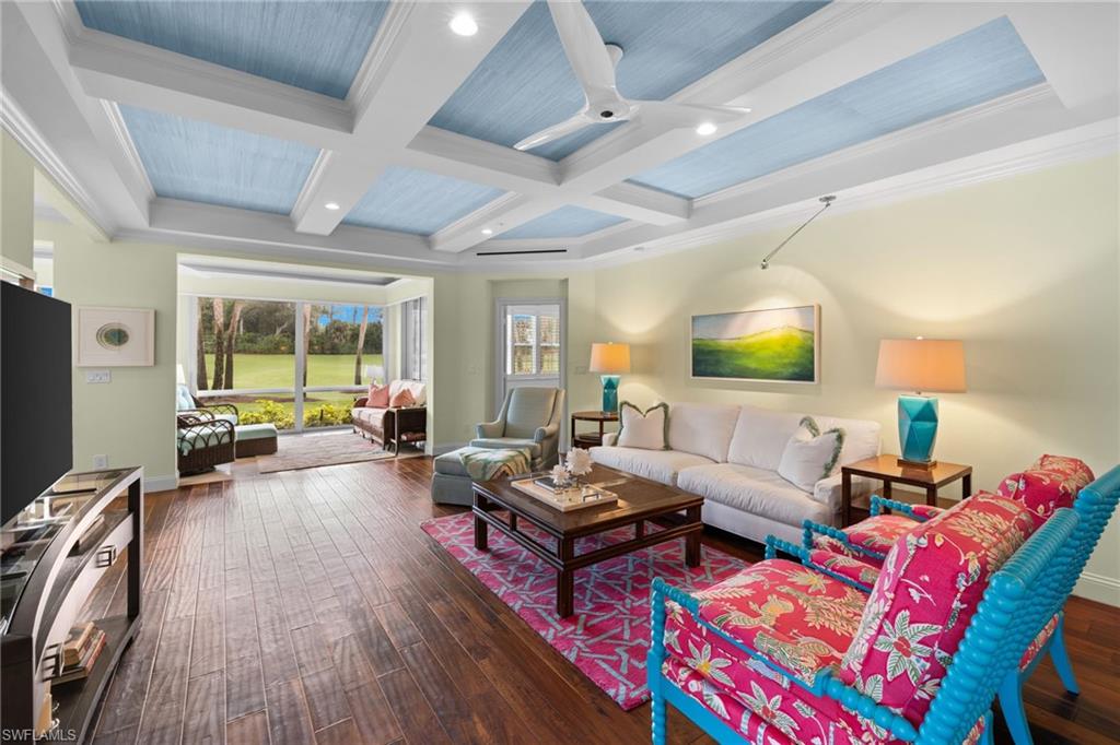 2120 Aberdeen Lane, Unit 101 Naples, FL 34109 - Photo 11 of 47 a living room with furniture and a flat screen tv