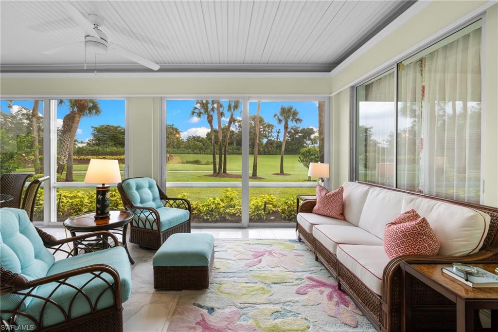 2120 Aberdeen Lane, Unit 101 Naples, FL 34109 - Photo 15 of 47 a living room with furniture and a large window