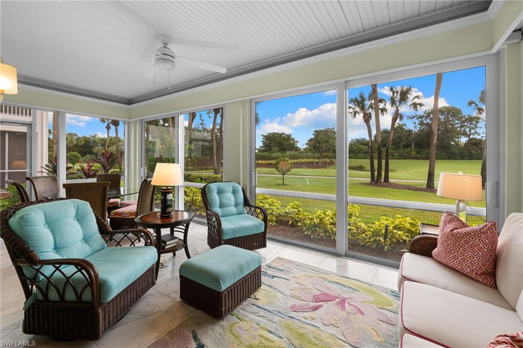 2120 Aberdeen Lane, Unit 101 Naples, FL 34109 - Photo 16 of 47 a living room with furniture and a large window