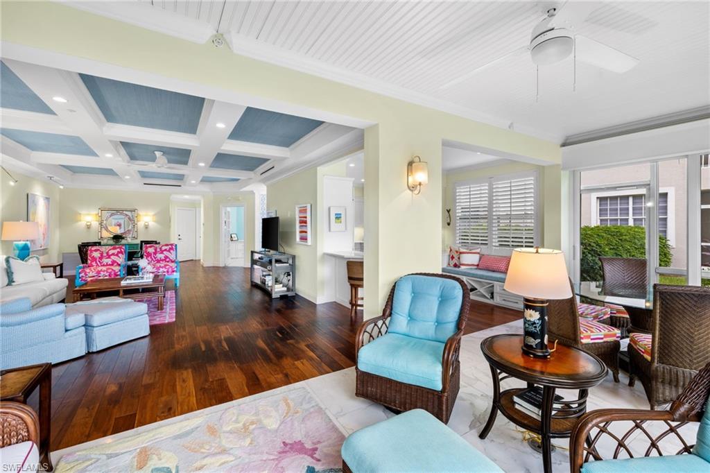 2120 Aberdeen Lane, Unit 101 Naples, FL 34109 - Photo 17 of 47 a living room with furniture and a chandelier
