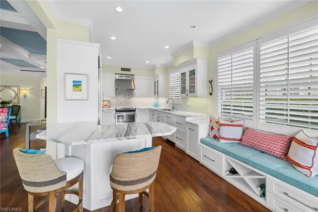 a dining room with furniture and a large window