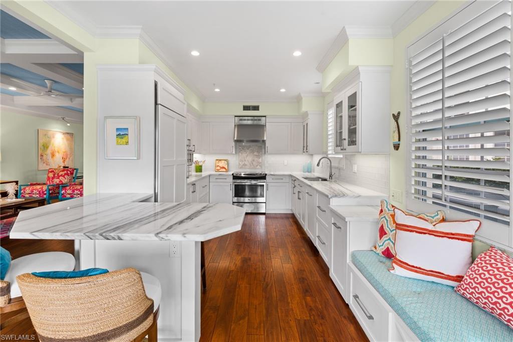 2120 Aberdeen Lane, Unit 101 Naples, FL 34109 - Photo 19 of 47 a large kitchen with stainless steel appliances kitchen island granite countertop a large counter top and white cabinets