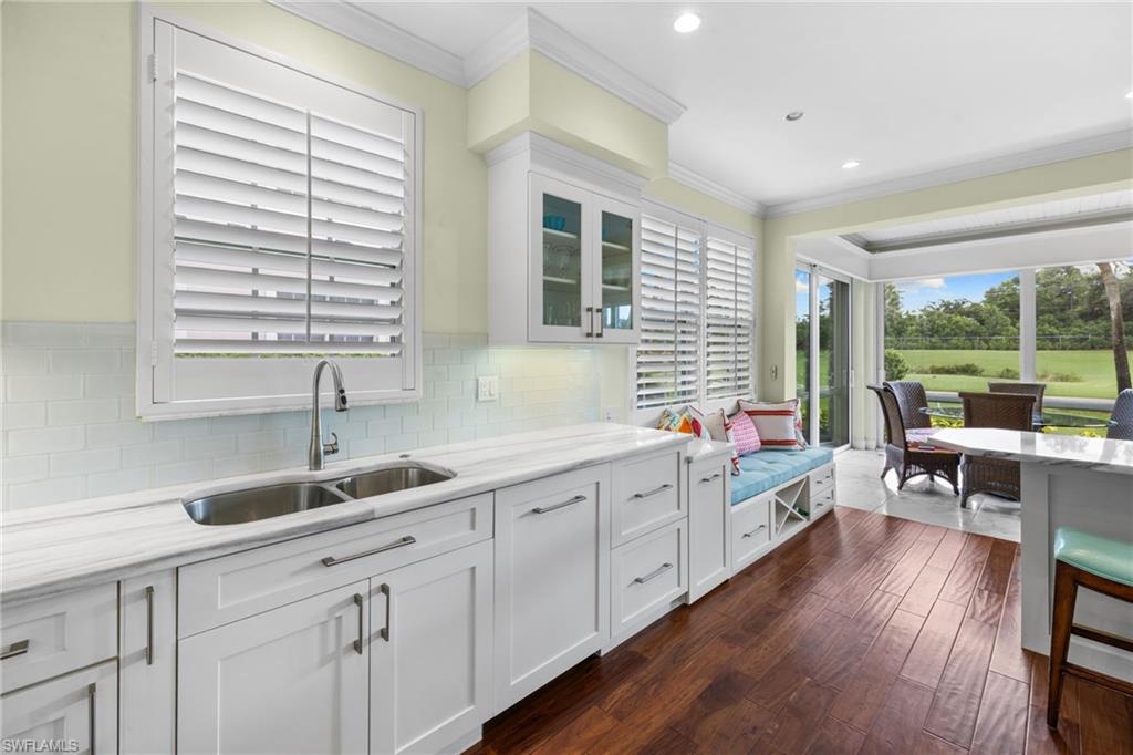 2120 Aberdeen Lane, Unit 101 Naples, FL 34109 - Photo 22 of 47 a kitchen with a sink and cabinets