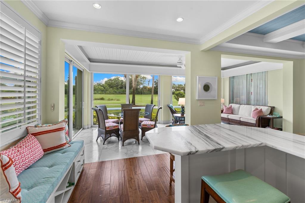 2120 Aberdeen Lane, Unit 101 Naples, FL 34109 - Photo 23 of 47 a living room with furniture and wooden floor