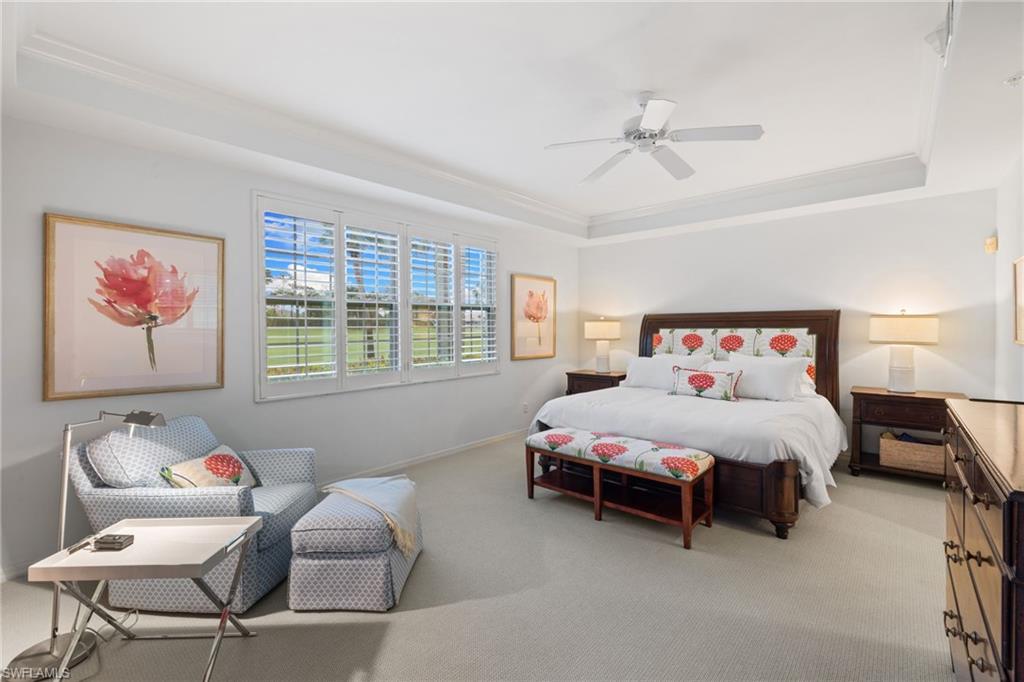 2120 Aberdeen Lane, Unit 101 Naples, FL 34109 - Photo 26 of 47 a bedroom with a bed and a chandelier