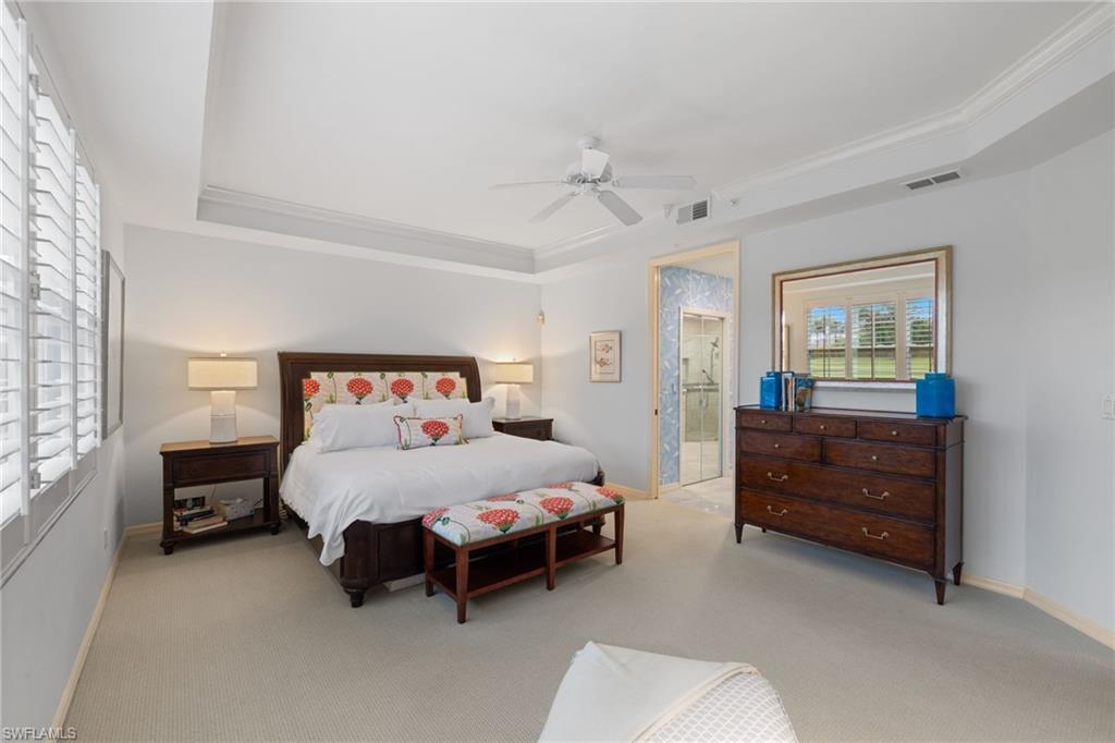 2120 Aberdeen Lane, Unit 101 Naples, FL 34109 - Photo 27 of 47 a bedroom with a bed and a dresser