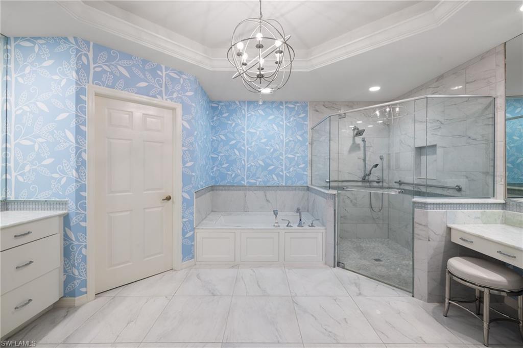 2120 Aberdeen Lane, Unit 101 Naples, FL 34109 - Photo 28 of 47 a spacious bathroom with a granite countertop sink a toilet a mirror and shower