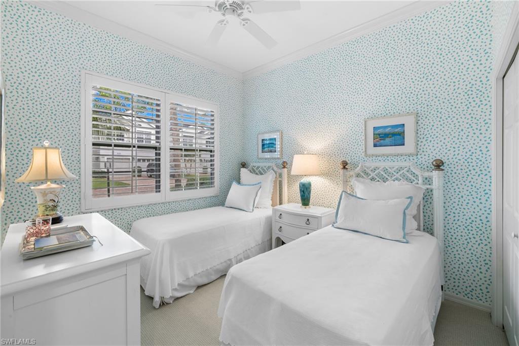 2120 Aberdeen Lane, Unit 101 Naples, FL 34109 - Photo 31 of 47 a bedroom with two beds and a large window