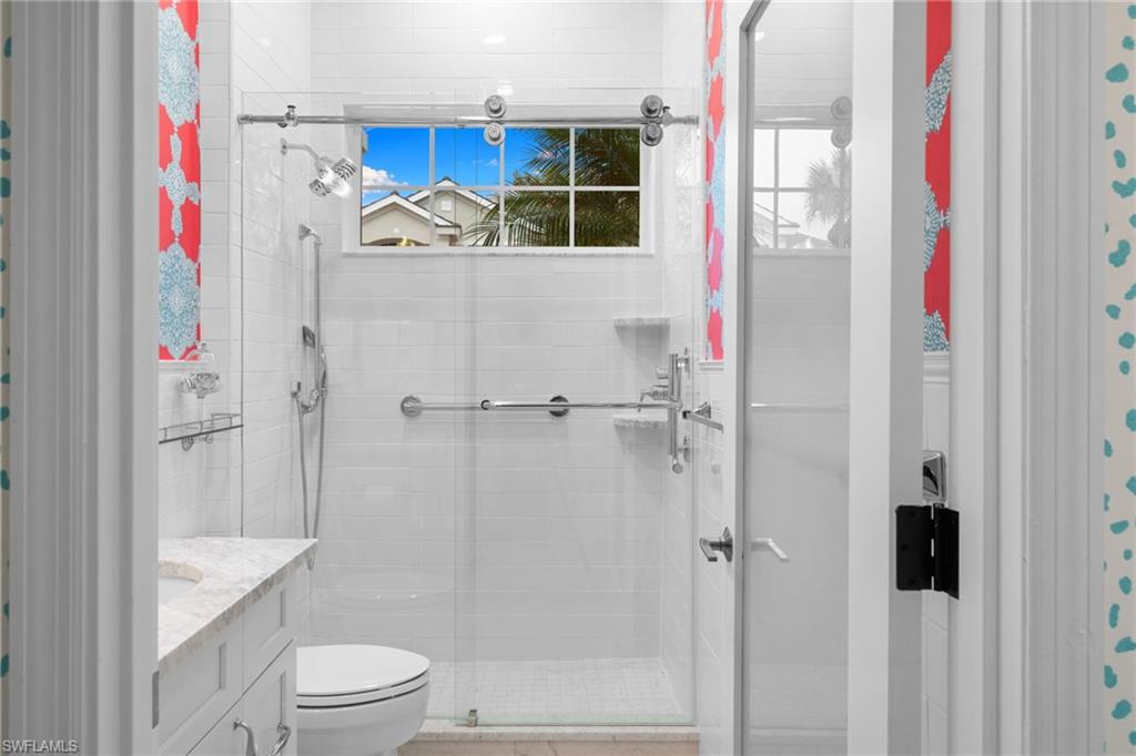 2120 Aberdeen Lane, Unit 101 Naples, FL 34109 - Photo 33 of 47 a bathroom with a shower and a toilet