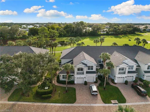 an aerial view of residential houses with outdoor space and ocean view