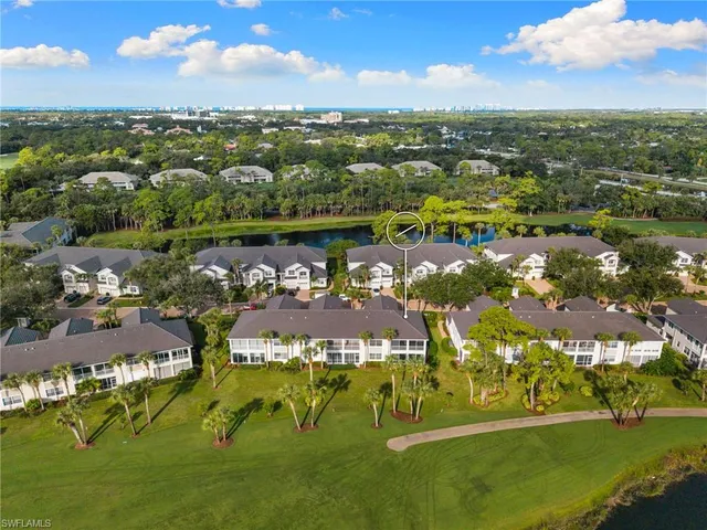 an aerial view of residential houses with outdoor space and lake view