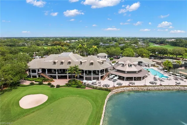 an aerial view of a house with swimming pool and lake view