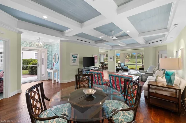 a dining room with furniture window and wooden floor