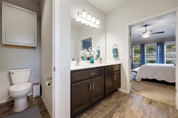 a spacious en suite bathroom with a double vanity sink and a large mirror